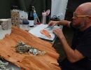 Ash tweezing the bones with a pair scissors